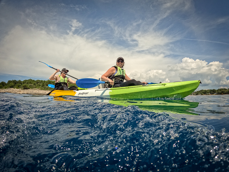 Two happy kayakers enjoying a fun-filled adventure on the tranquil waters of Pula