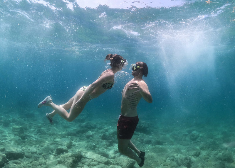 Underwater bliss: A couple snorkeling together, capturing a tender moment as they prepare to share a kiss beneath the sea.