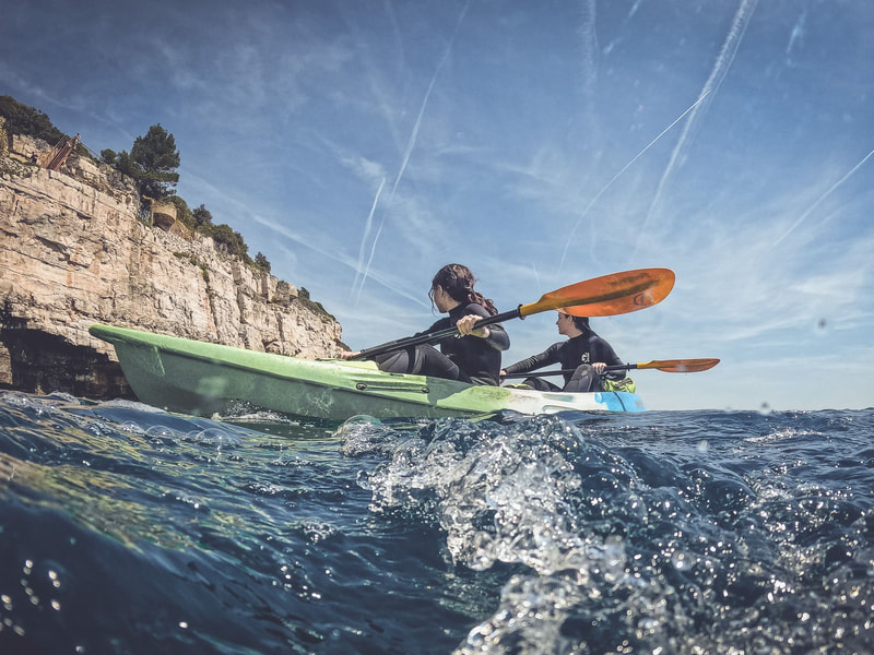 Kayakers exploring the stunning coastline of Pula, gliding through crystal-clear waters and marveling at the beauty of nature.